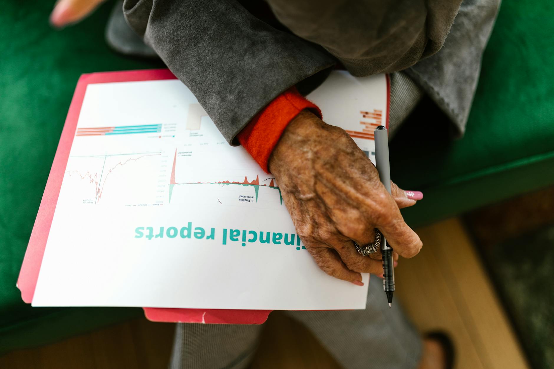 Business professionals reviewing financial documents during a portfolio acquisition meeting