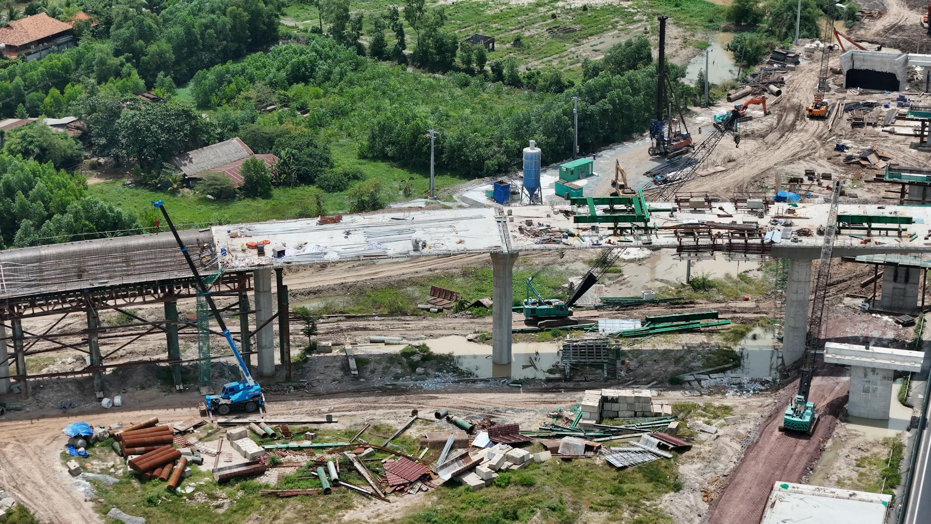 Infrastructure construction site showing a bridge project dependent on public funding