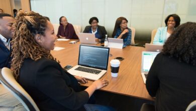 Business executives reviewing investment documents in a formal boardroom setting
