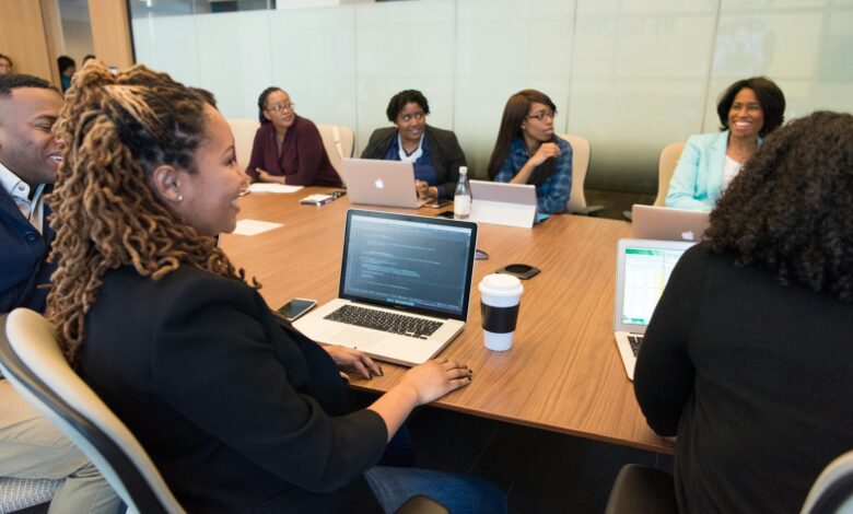 Business executives reviewing investment documents in a formal boardroom setting