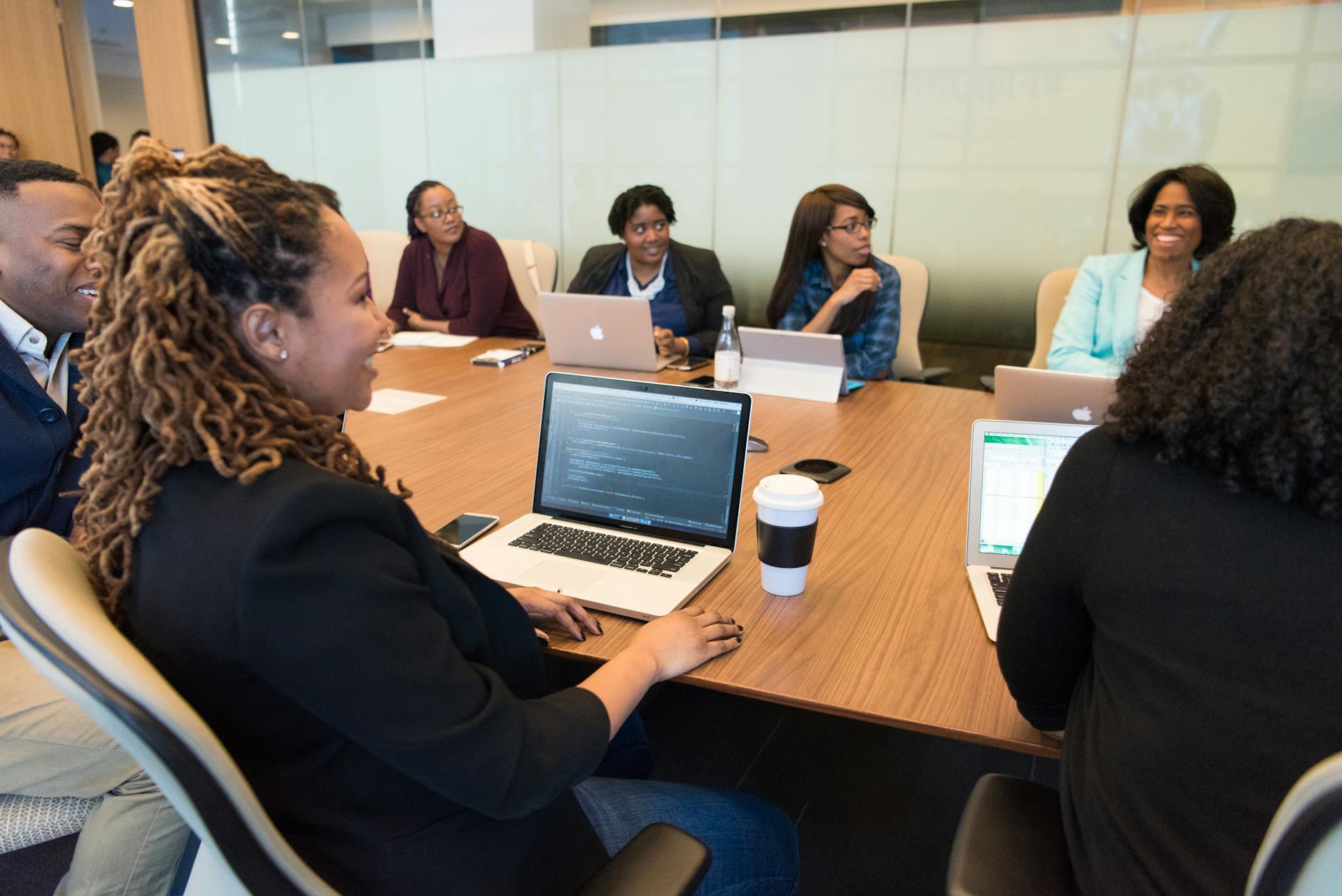 Business executives reviewing investment documents in a formal boardroom setting