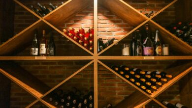 Rows of fine wine bottles stored in a dark stone cellar