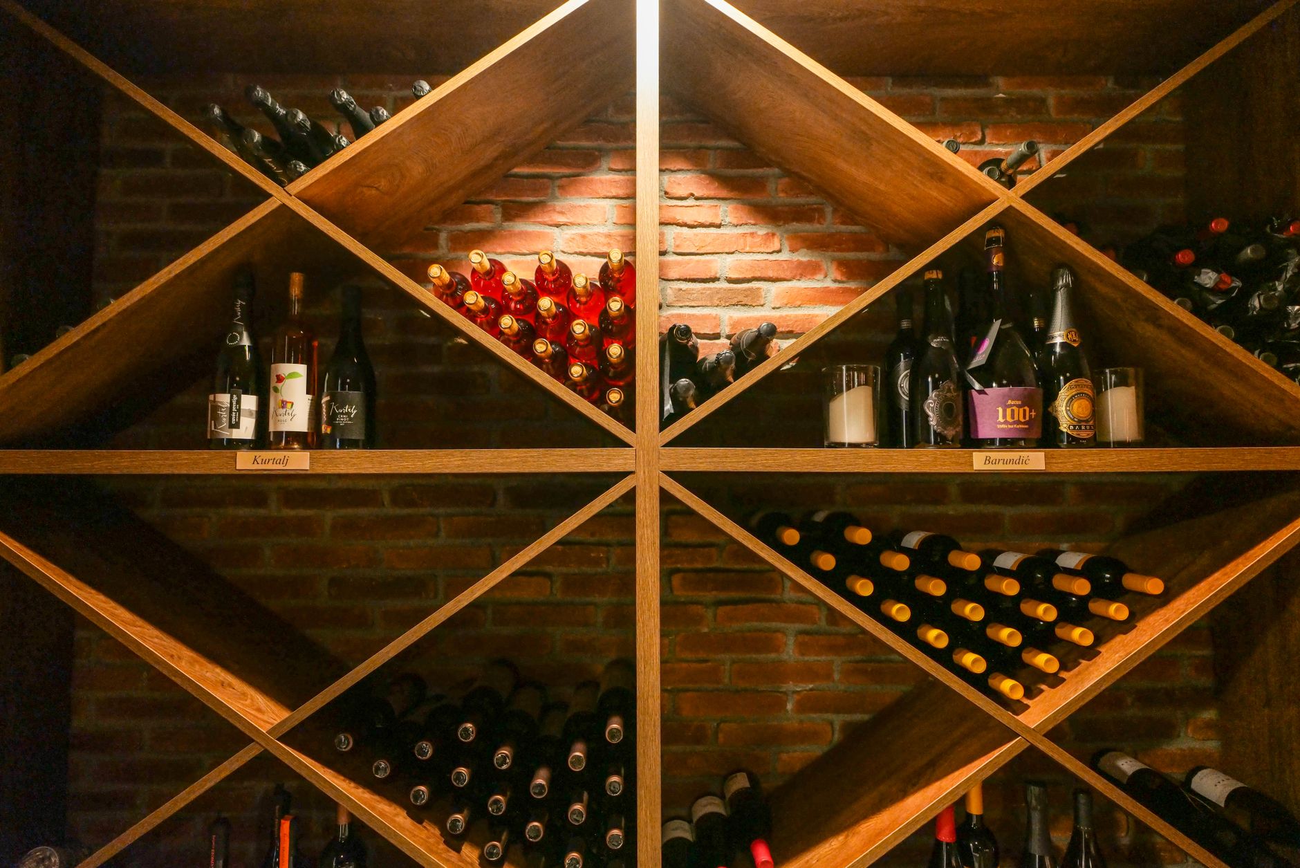 Rows of fine wine bottles stored in a dark stone cellar