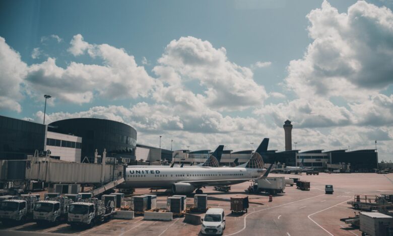 Empty airport terminal with gates and large windows showing parked aircraft