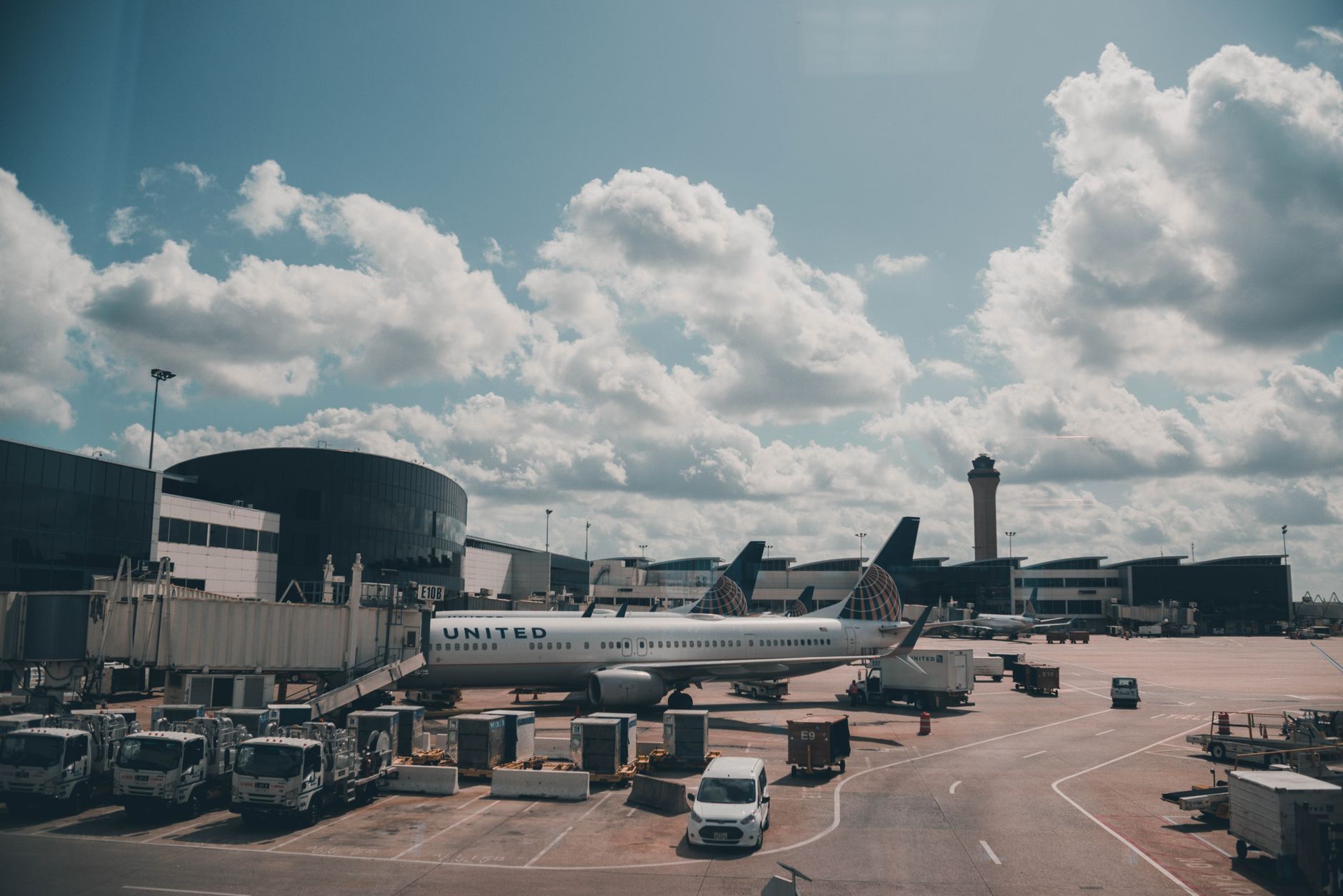 Empty airport terminal with gates and large windows showing parked aircraft