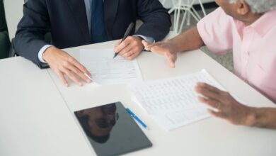 Insurance and financial documents spread across a desk representing reinsurance contract review