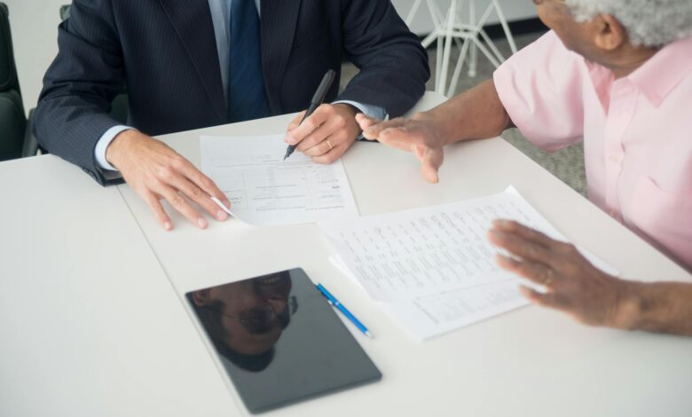 Insurance and financial documents spread across a desk representing reinsurance contract review