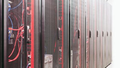 Rows of servers inside a large data center facility with blue lighting