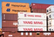 Rows of stacked intermodal shipping containers at a commercial port