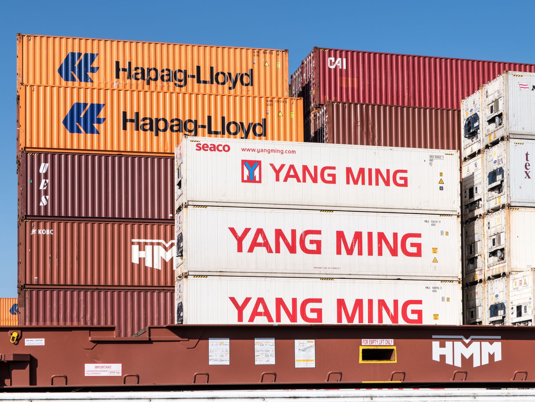 Rows of stacked intermodal shipping containers at a commercial port