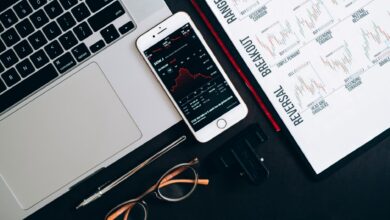 Traders working at a financial desk analyzing bond market data on multiple screens