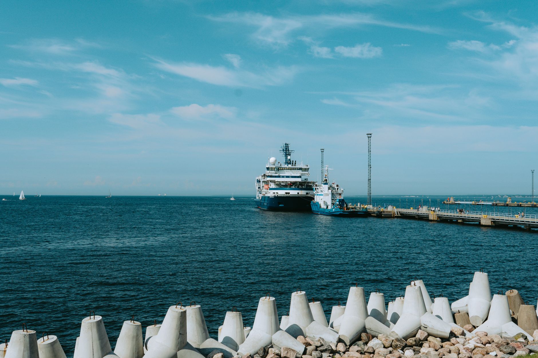 Large liquefied natural gas terminal with storage tanks along a coastal industrial waterfront