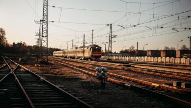 Long freight train moving through open countryside representing railroad infrastructure investment
