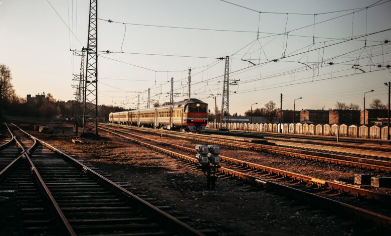 Long freight train moving through open countryside representing railroad infrastructure investment