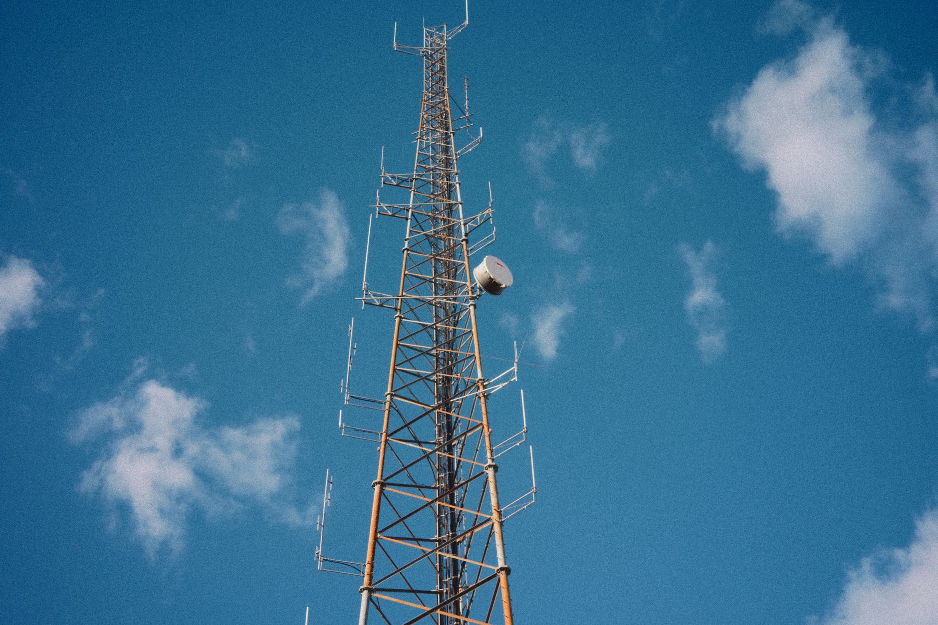 Aerial view of a broadcast communications tower standing in an open landscape