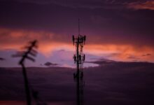 Aerial view of a cell tower mounted on a rooftop in a suburban area