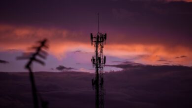Aerial view of a cell tower mounted on a rooftop in a suburban area