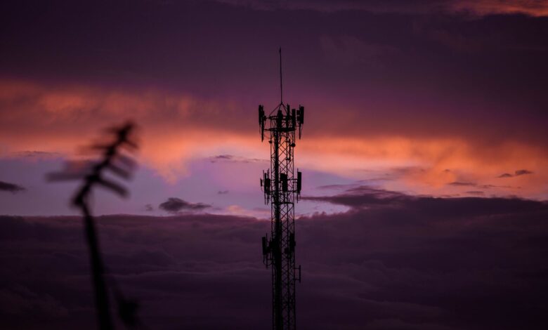 Aerial view of a cell tower mounted on a rooftop in a suburban area