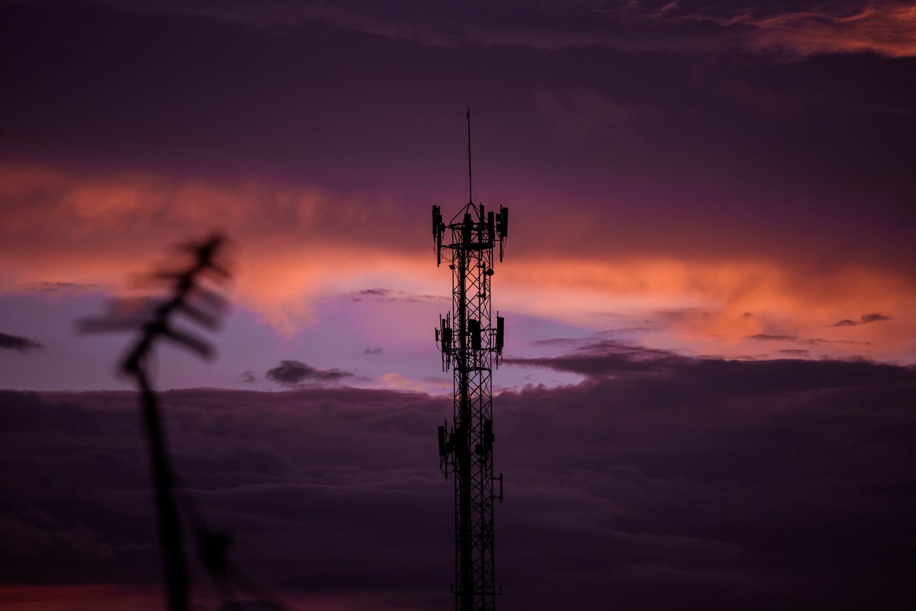 Aerial view of a cell tower mounted on a rooftop in a suburban area