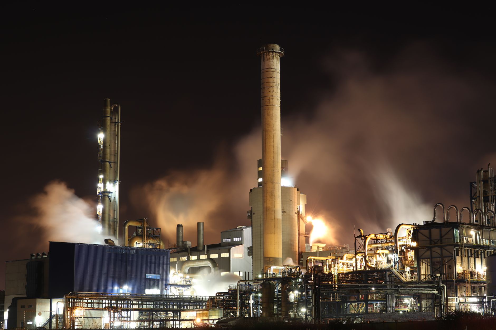 Industrial facility with large smokestacks used in carbon capture operations