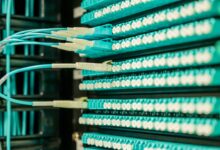 Close-up of fiber optic cables bundled together in an underground conduit