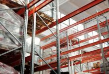 Large industrial warehouse interior with high shelving and open floor space