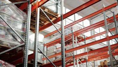 Large industrial warehouse interior with high shelving and open floor space
