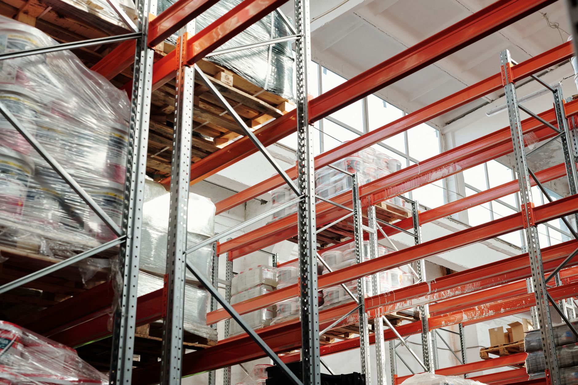Large industrial warehouse interior with high shelving and open floor space