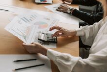 Family office professionals reviewing investment fund documents at a conference table