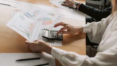 Family office professionals reviewing investment fund documents at a conference table