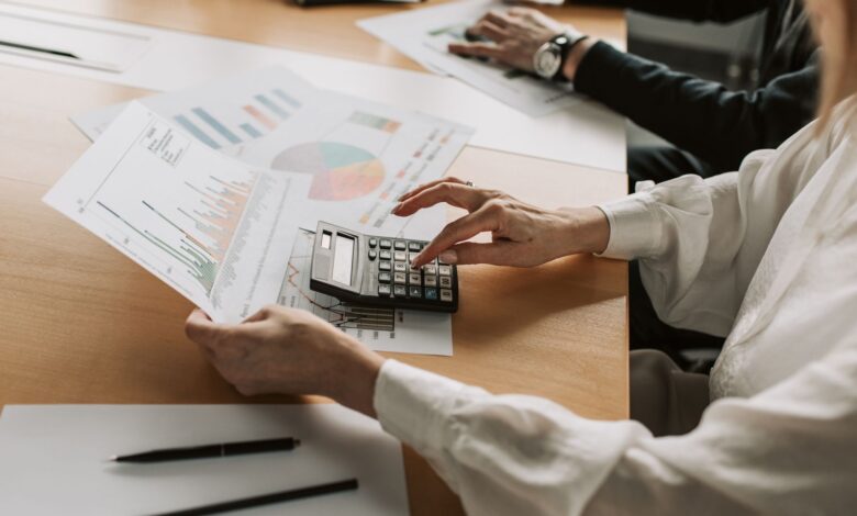 Family office professionals reviewing investment fund documents at a conference table