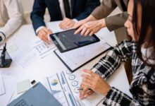 Financial advisors reviewing investment documents at a conference table
