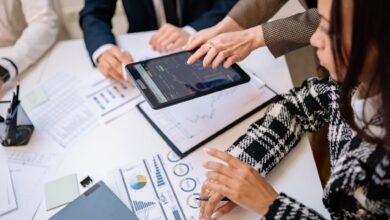 Financial advisors reviewing investment documents at a conference table