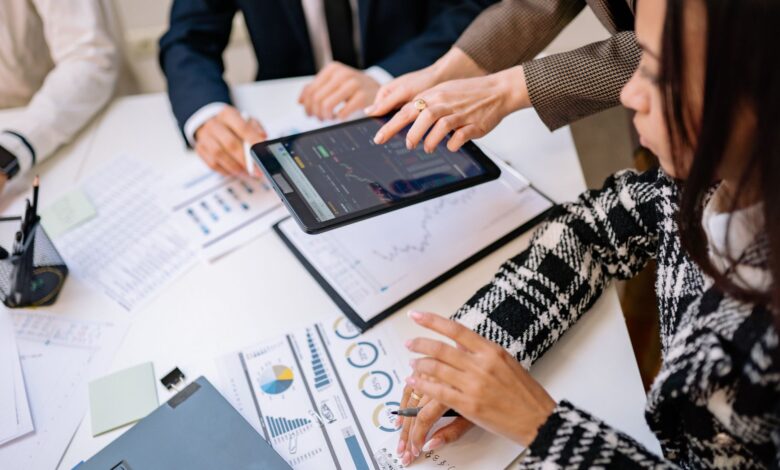 Financial advisors reviewing investment documents at a conference table