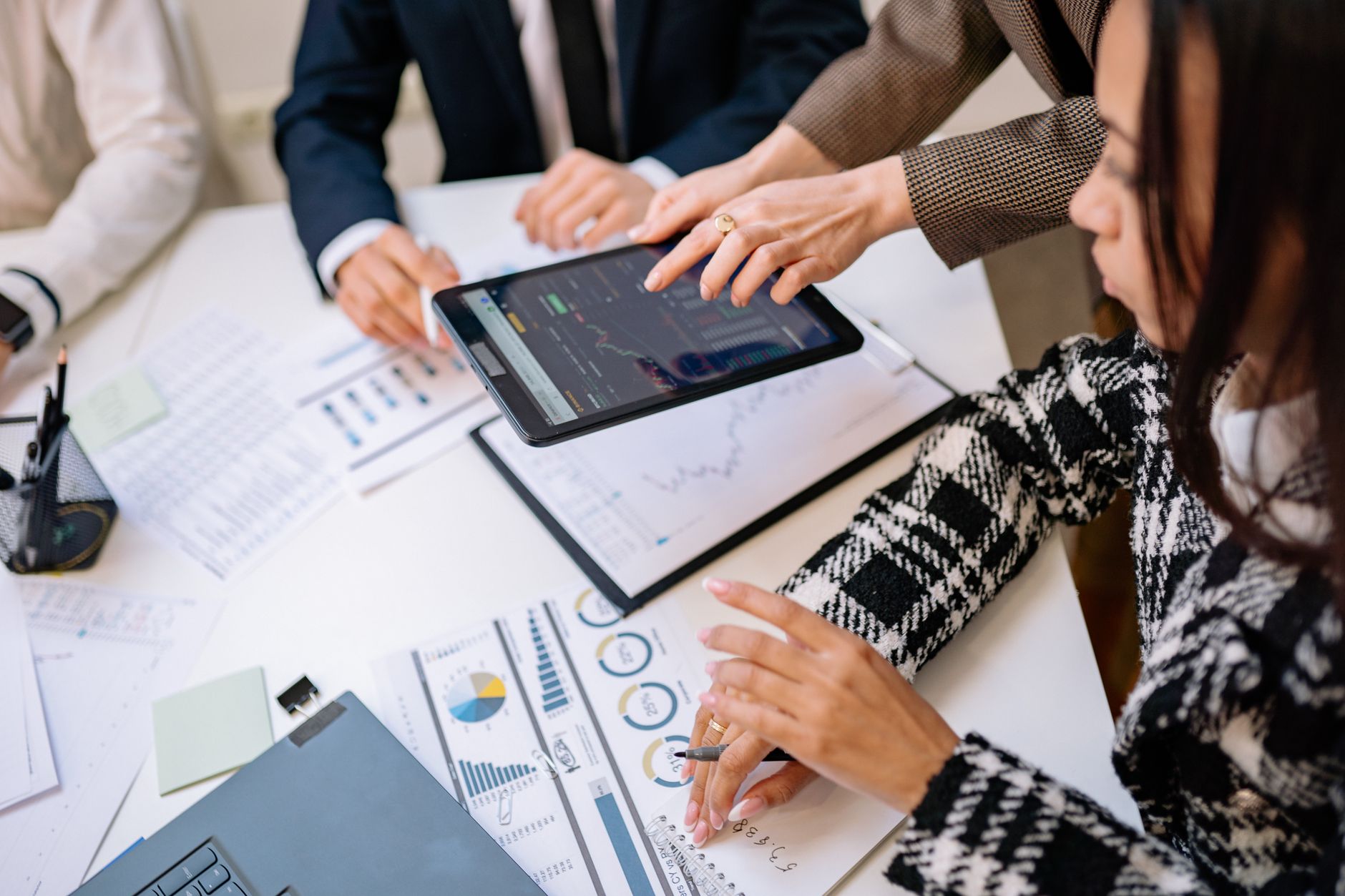 Financial advisors reviewing investment documents at a conference table