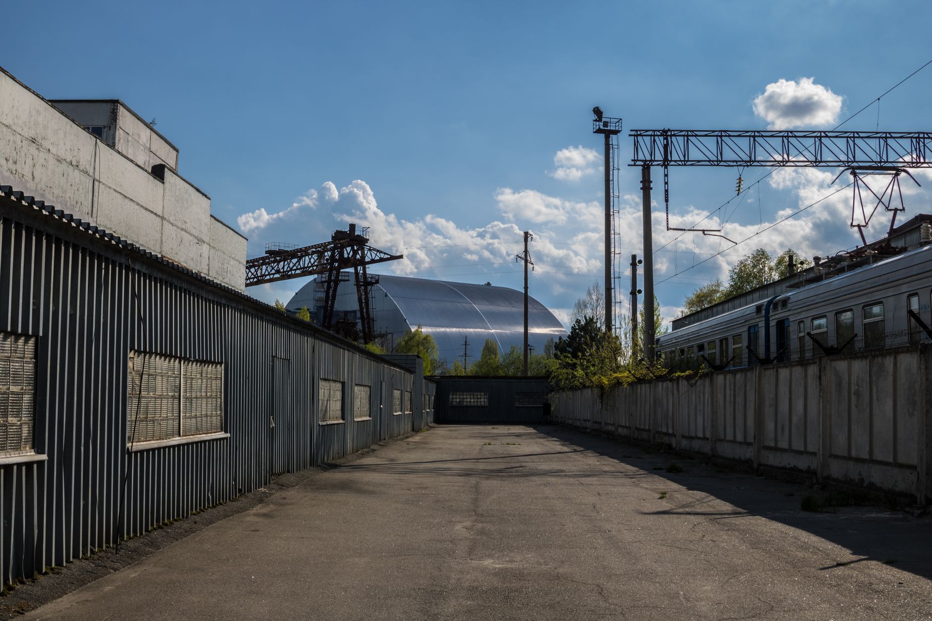 Nuclear power plant cooling towers with steam rising against a clear sky