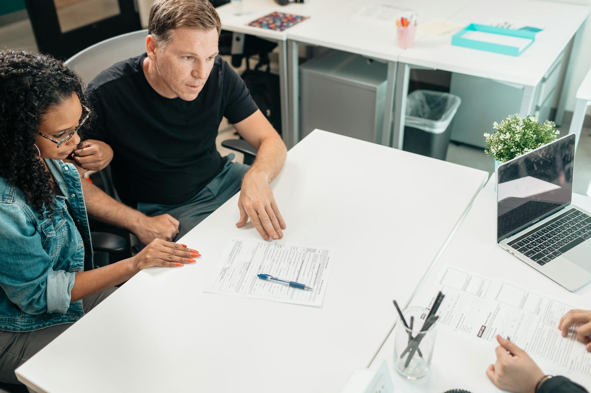 Financial advisor reviewing portfolio documents at an office desk