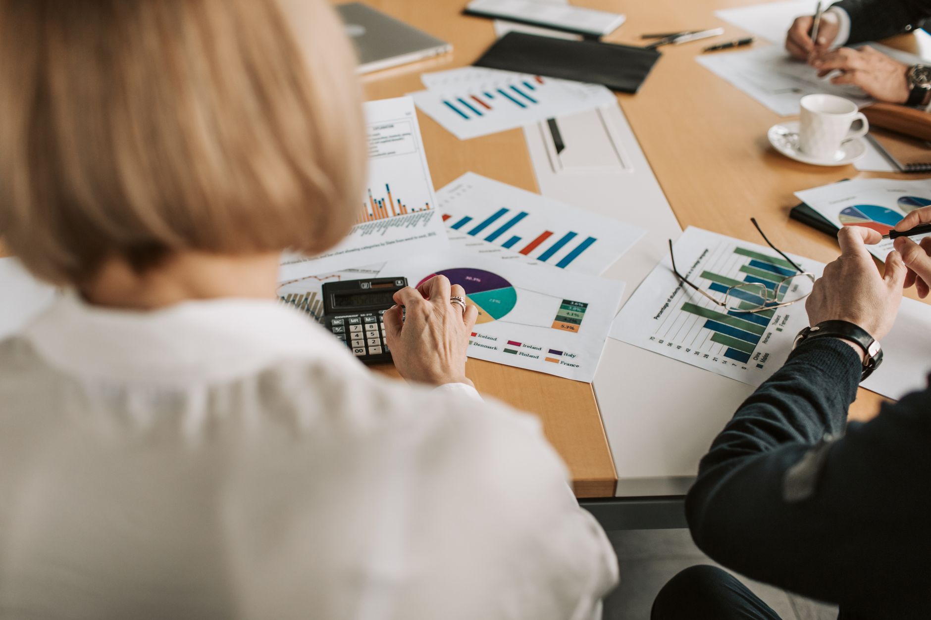 Institutional investors reviewing portfolio allocation documents at a conference table