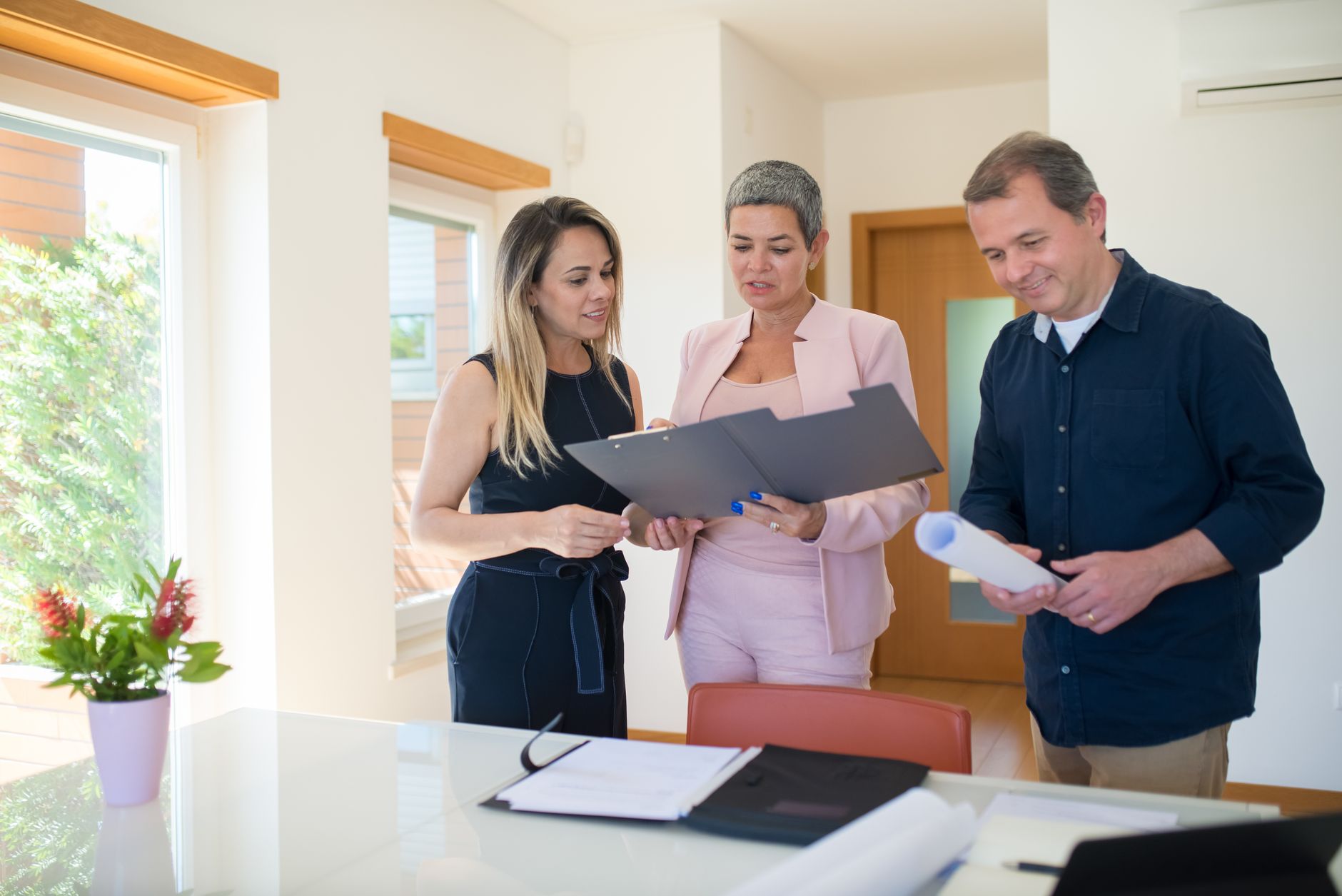 Business professionals reviewing real estate documents at a conference table