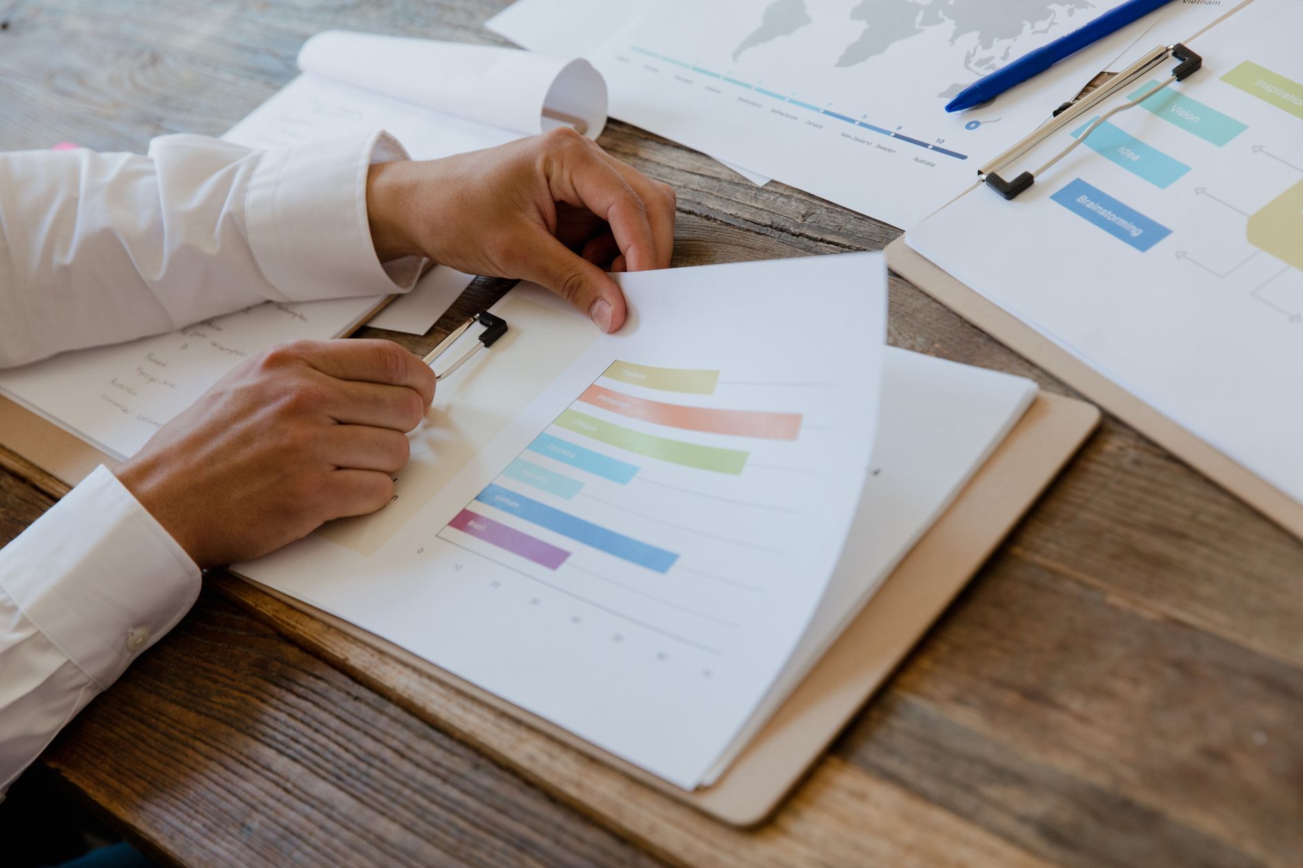 Investment documents and financial analysis materials spread across a desk representing CMBS tranche underwriting work