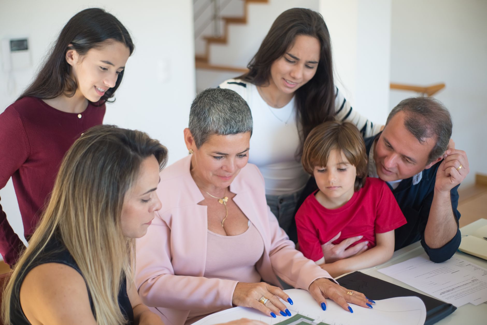 Wealth management professionals reviewing investment documents in a private office setting
