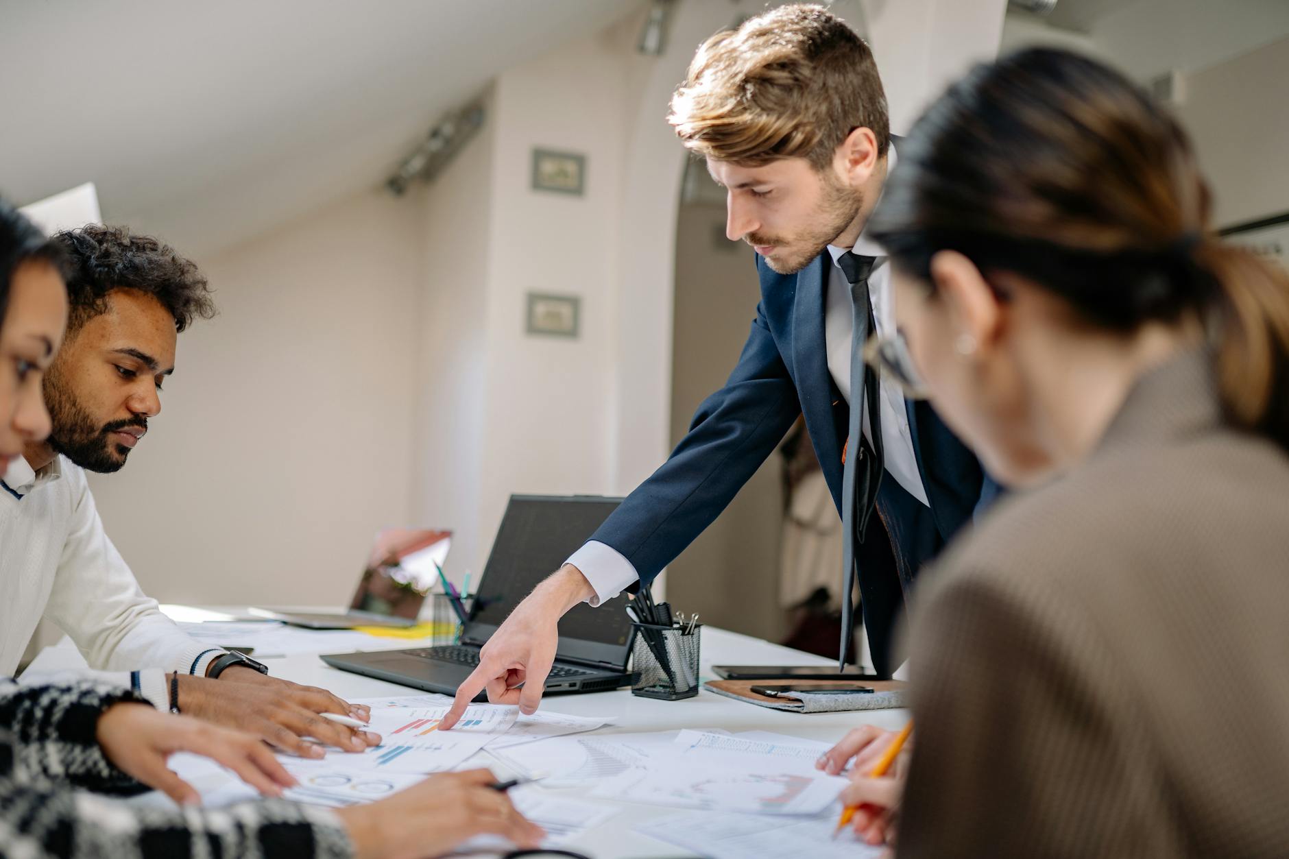 Family office professionals discussing investment strategy in a conference room