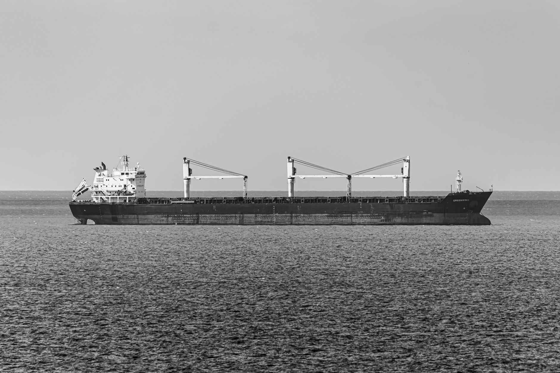 Large container cargo ship sailing on open ocean