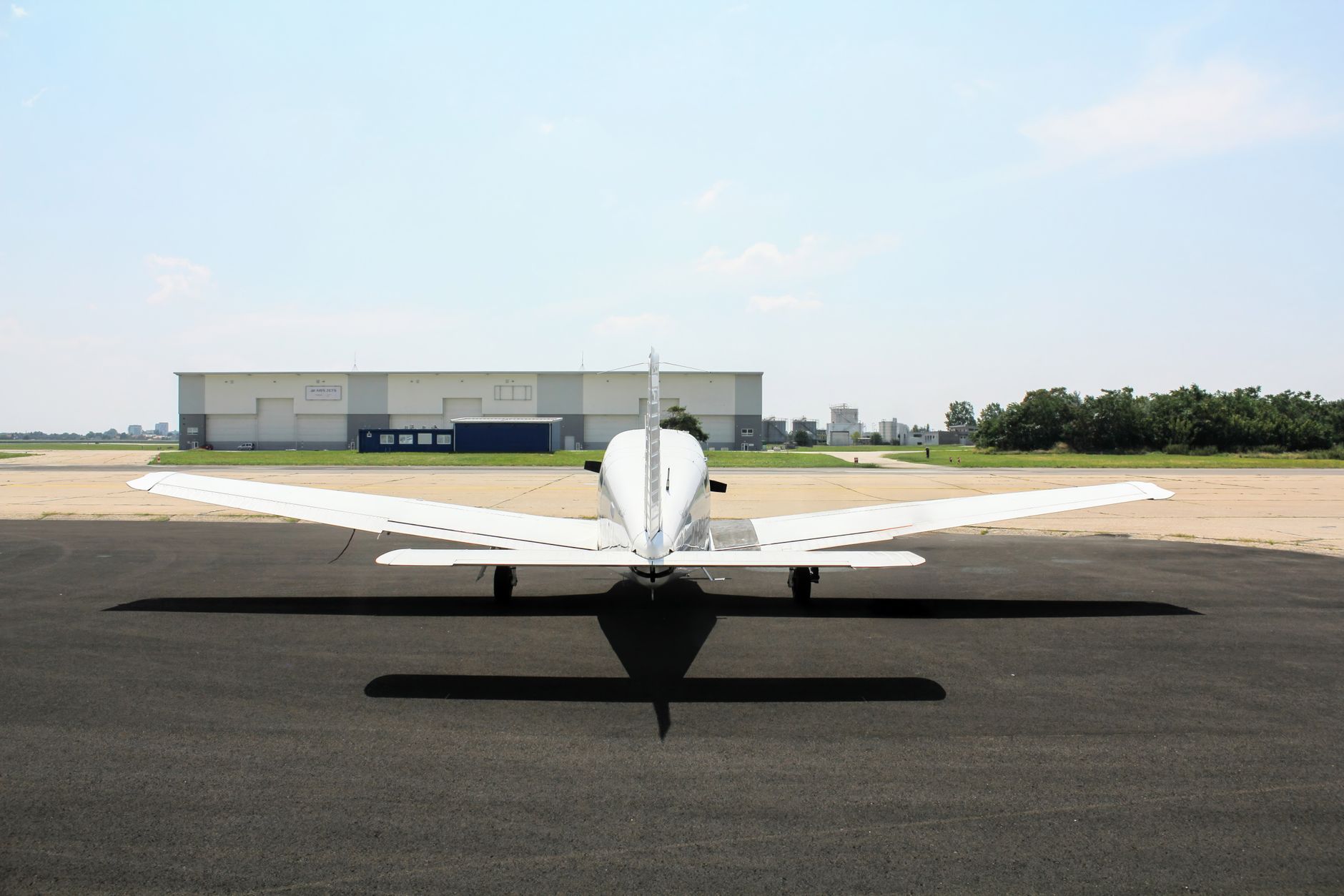 Large commercial aircraft parked inside an industrial maintenance hangar