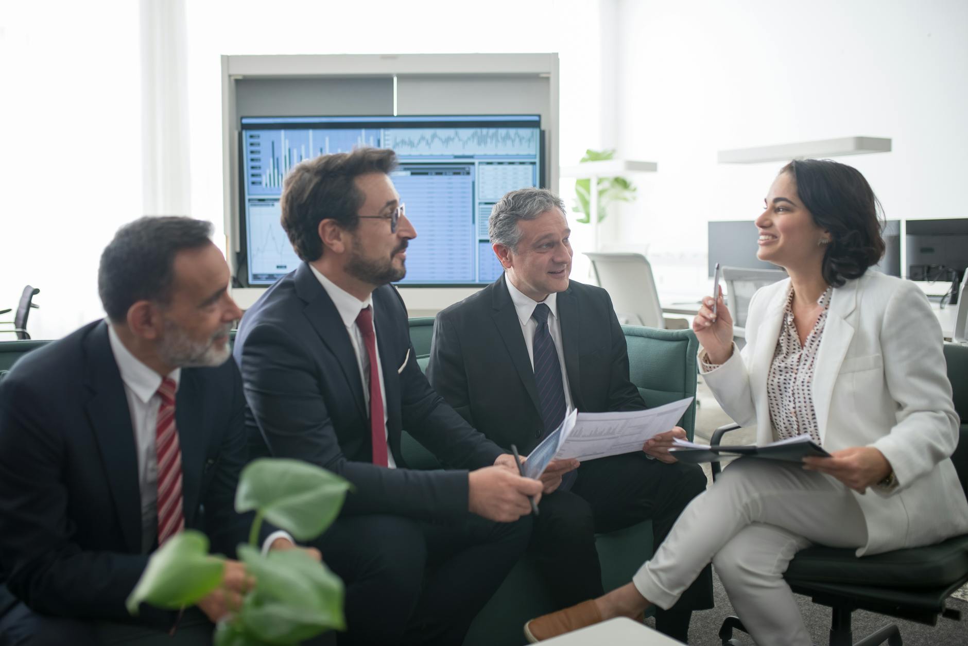 Professional meeting between wealth advisors reviewing portfolio documents