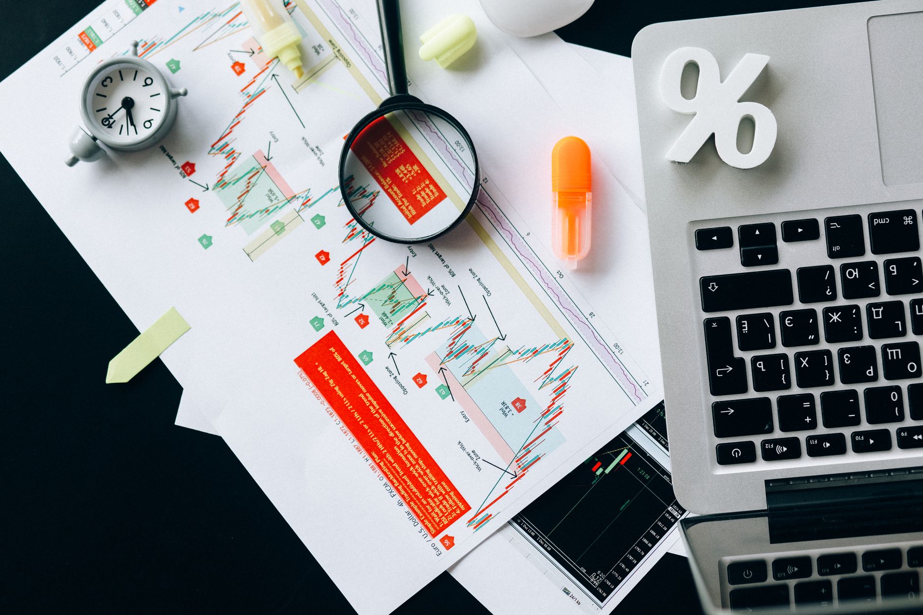 Financial charts on a desk representing portfolio risk analysis and alternative investments