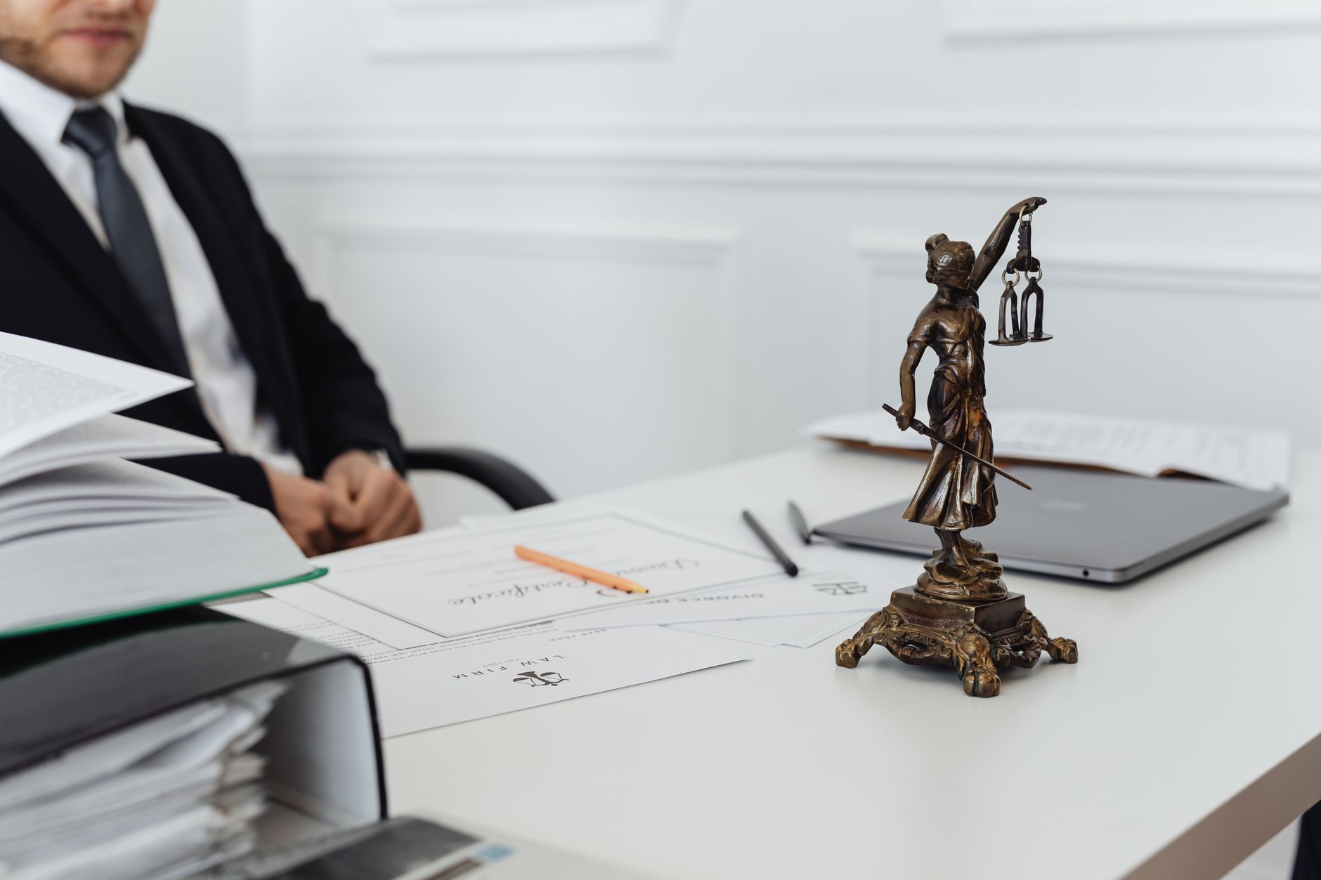 Legal documents and property title papers spread across a desk in an office setting