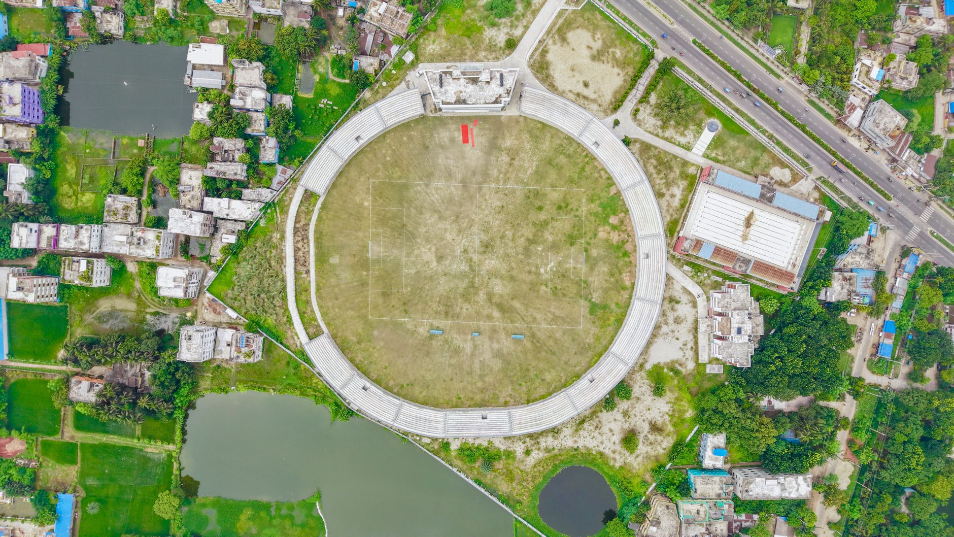 Aerial view of a stadium surrounded by urban development