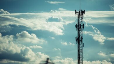 Wireless cell tower against a clear sky representing infrastructure ground lease investments