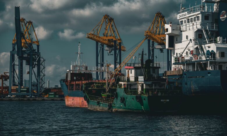 Large cargo ship docked at a commercial shipping port with stacked containers